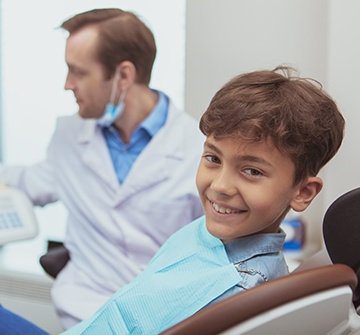 Child with dental sealants smiling in dental office