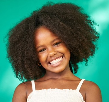 Young girl with tooth-colored fillings in Clinton, MA smiling