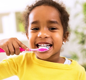 Closeup of young girl brushing her teeth