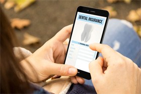 Patient looking at dental insurance information on phone