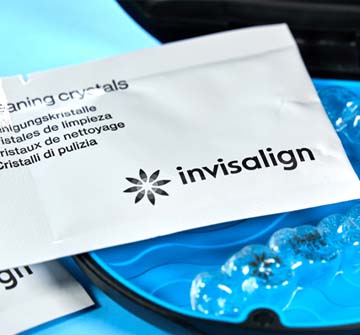 Closeup of Invisalign cleaning crystals and aligners on tray