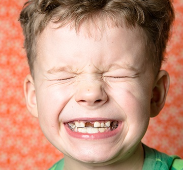 Child with phase one pediatric orthodontics smiling