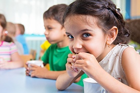 Closeup of child wearing blue mouthguard