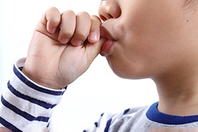 Closeup of child sucking their thumb