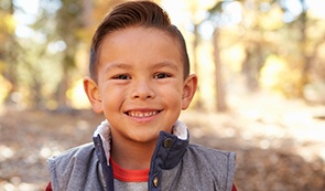 Young boy leaning against wall after dentistry for children visit