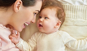 Mother and baby smiling after dentistry for infants visit