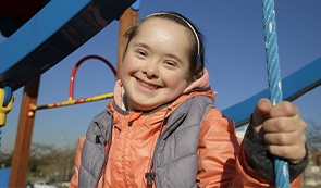 Laughing girl outdoors after special needs dentistry visit