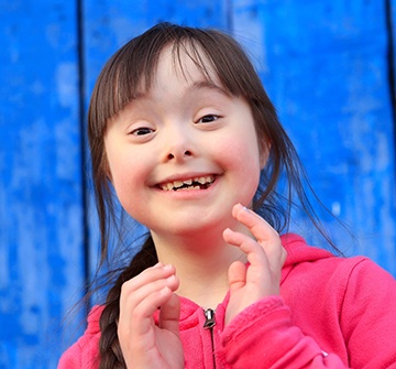 Young girl smiling after special need dentistry visit