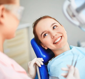 Teen smiling during dental checkup and teeth cleaning visit
