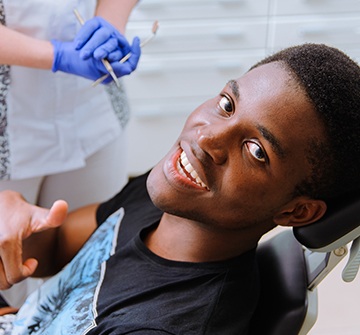 Young man smiling after receiving dental sealants