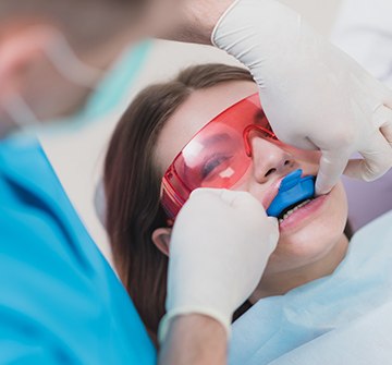 Teen receiving fluoride treatment