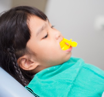 Child receiving fluoride treatment