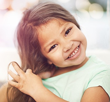 Toddler smiling after tooth colored fillings